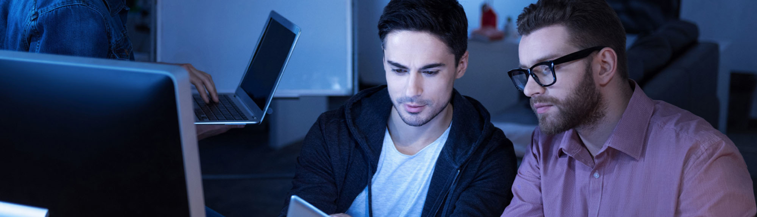 Team sit together for meeting over desktop screen