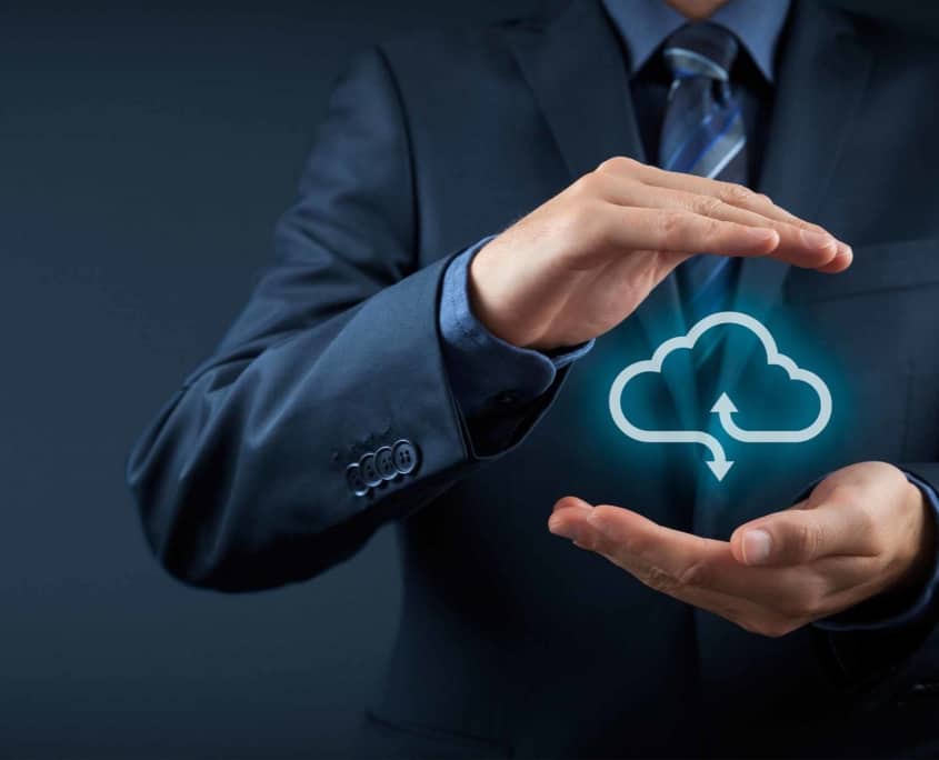 man in suit cups hands around cloud graphic