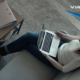 birds-eye view of woman sitting on couch holding a laptop
