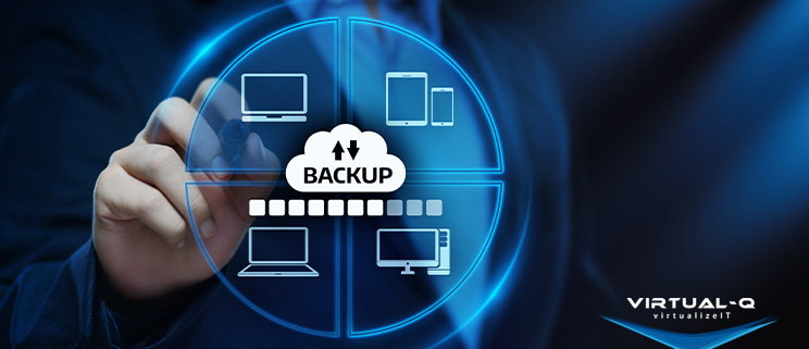 VirtualQ_LinkedIn_April1 man in suit holds up stylus behind circular graphic of hardware devices and word "backup"