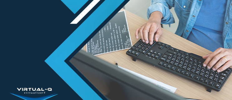 man types on keyboard next to blue and white background and Virtual-Q logo