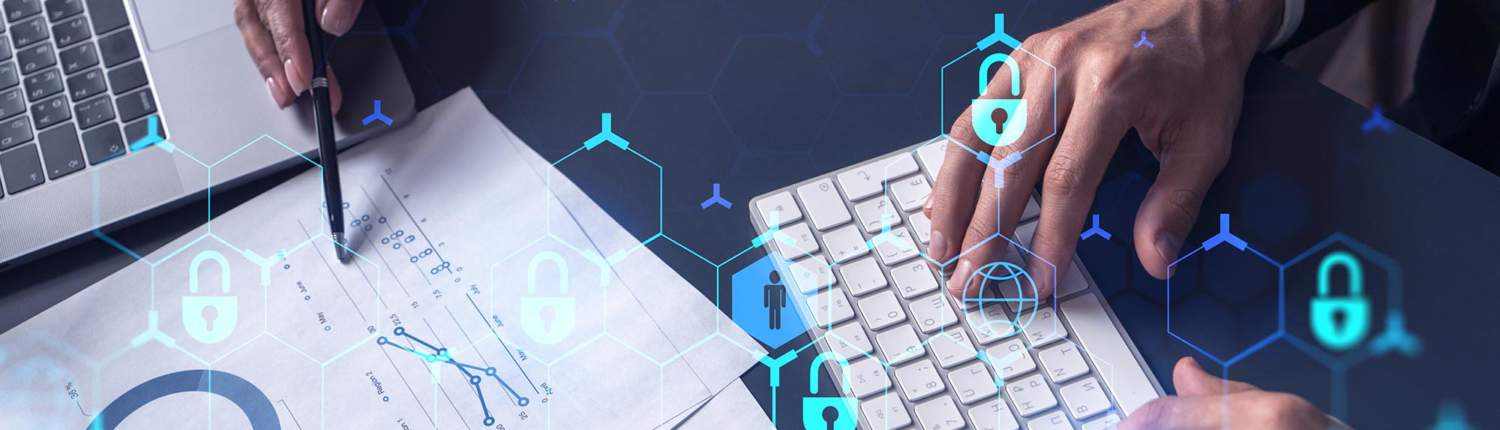 Importance of Cybersecurity Assessments December Blog 1 man with laptop reviews paper notes while coworker types on keyboard