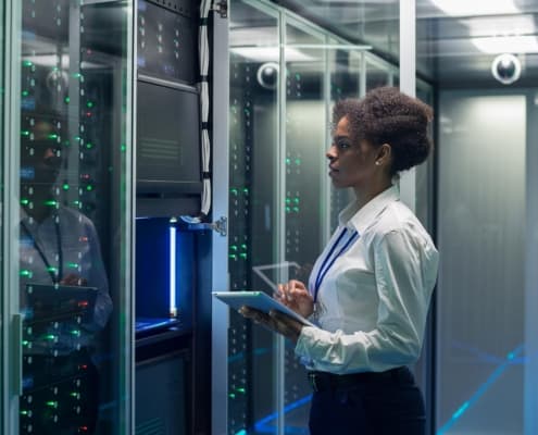 Image of a person using a tablet inside of a data center.