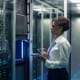 Image of a person using a tablet inside of a data center.