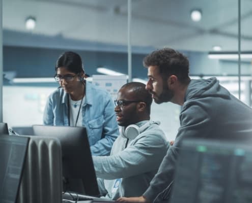 Image of people looking at a computer together.