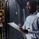 Person in a data center using a clipboard